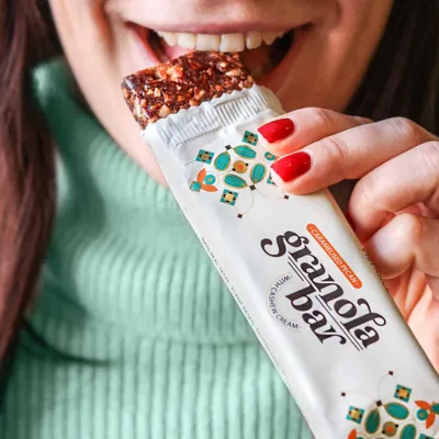 girl is eating a pecan granola bar