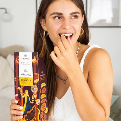 girl is eating peanut cacao protein granola